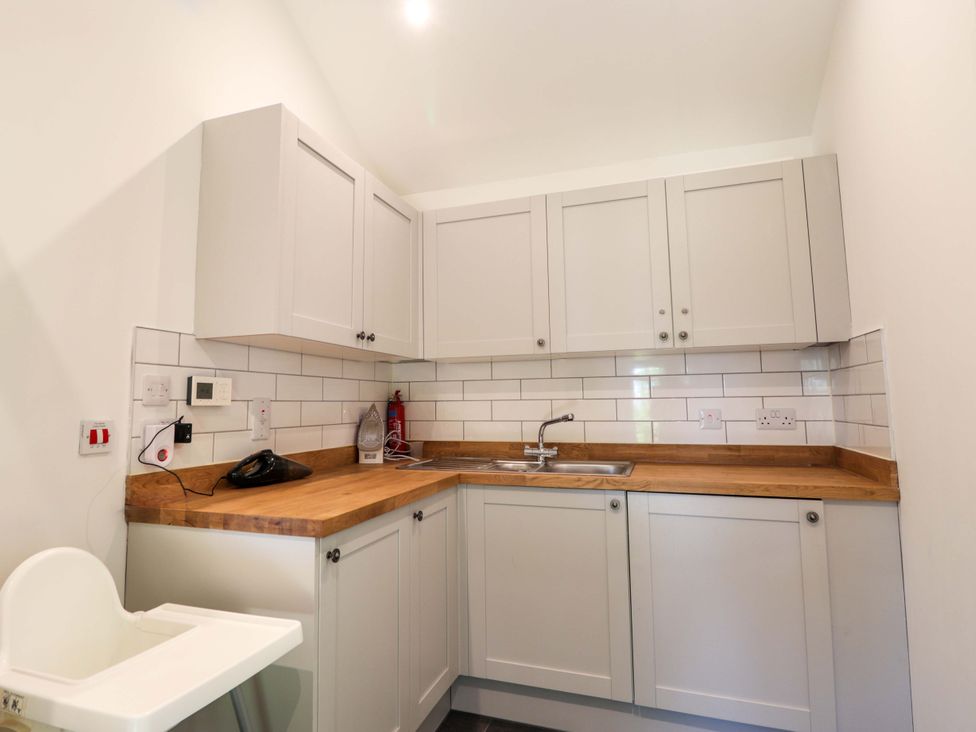 A kitchen with cabinets and sink at The Lookout in Saasaig near Broadford