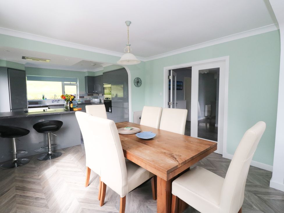 A dining room with a table and chairs at Am Bruaich, Tayvallich