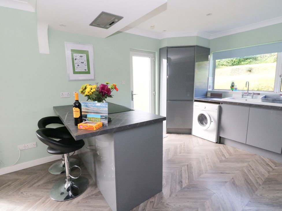 A kitchen with a bar and appliances at Am Bruaich in Tayvallich