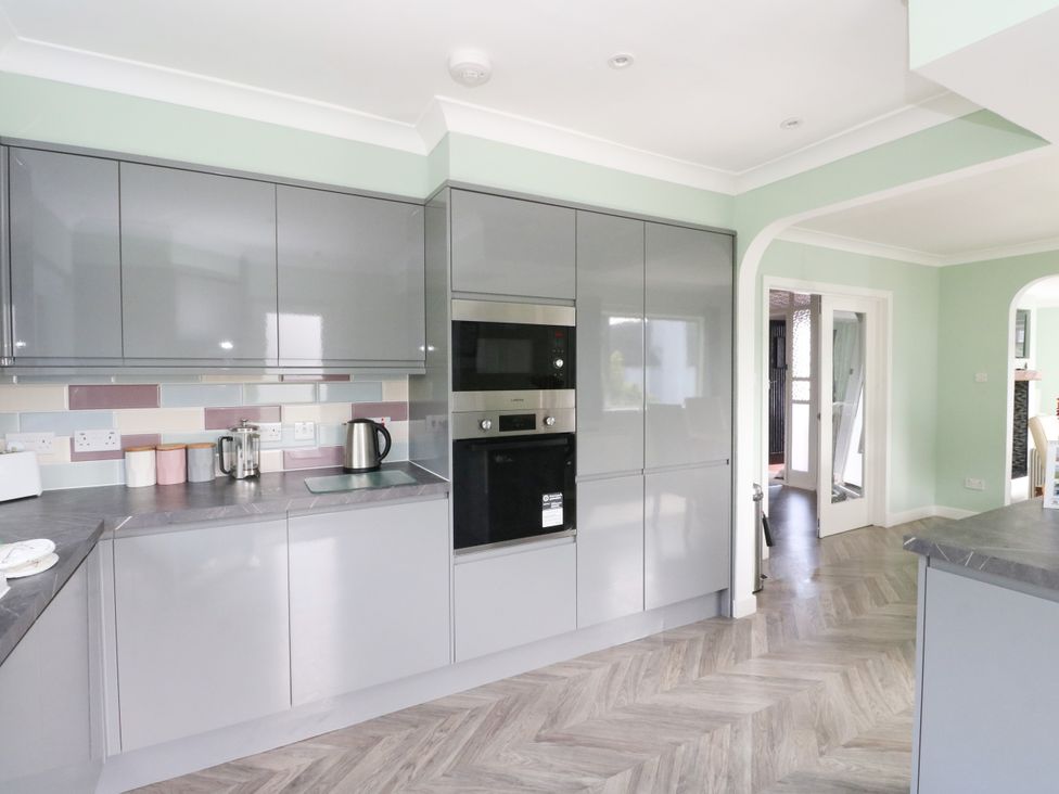 A kitchen with cabinets and appliances at Am Bruaich in Tayvallich