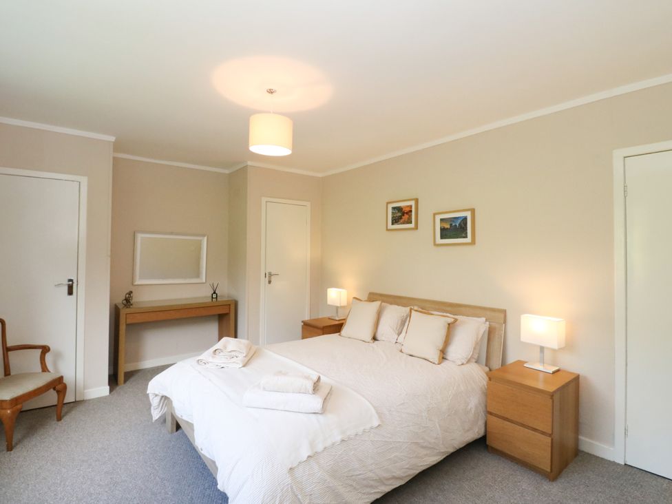 A bedroom with a bed and nightstands at Am Bruaich in Tayvallich