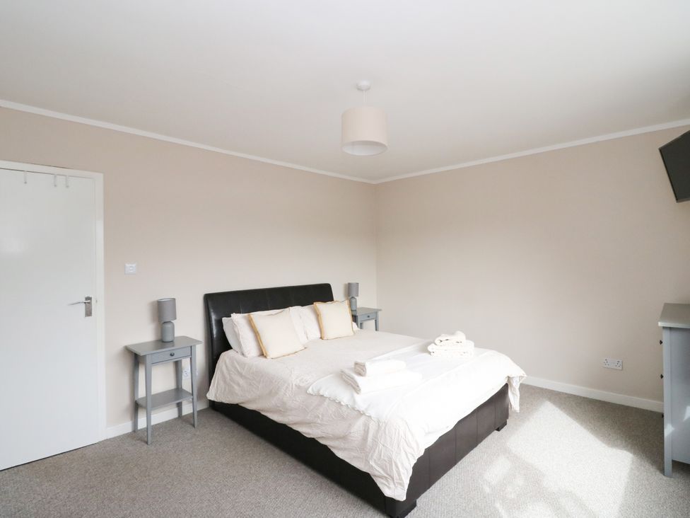 A bedroom with a bed and bedside tables at Am Bruaich in Tayvallich