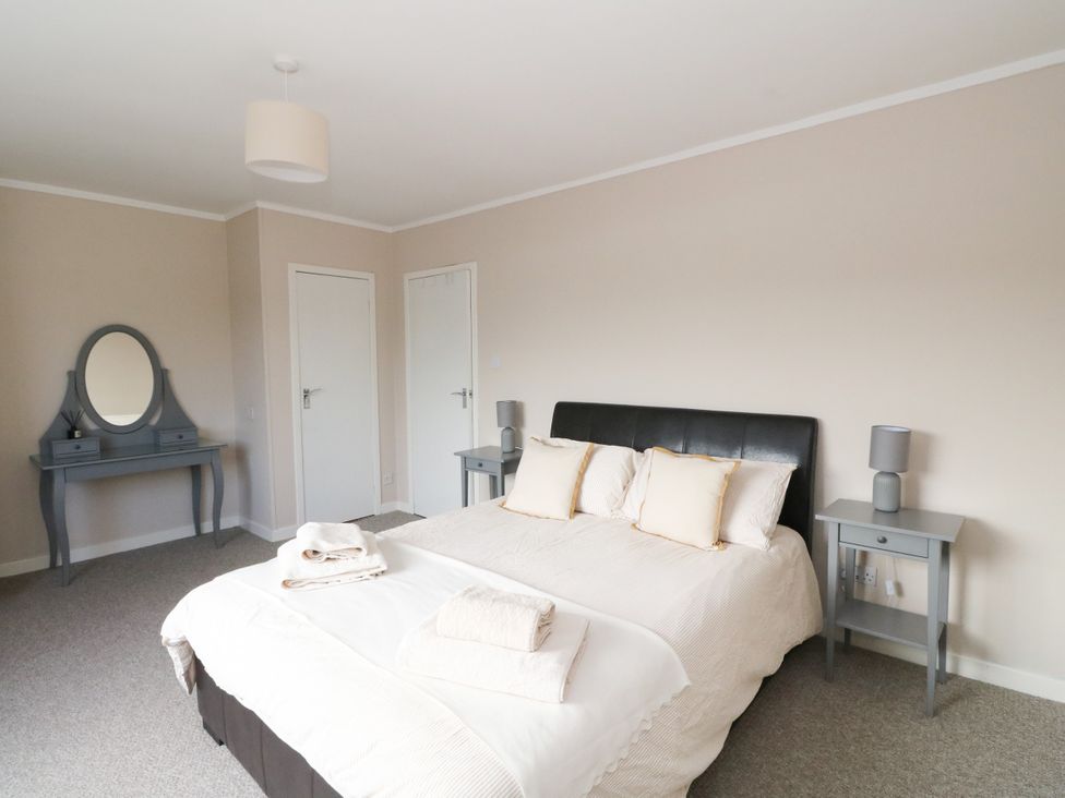 A bedroom with a bed and nightstands at Am Bruaich in Tayvallich