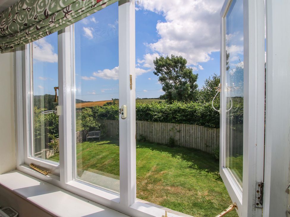 A window view of a garden at Brynlikky Cottage Chapel Lawn near Bucknell