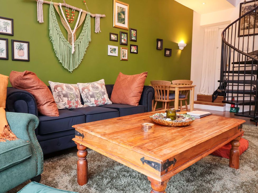 A living room with a sofa and coffee table at The Coach House, The Grove Combe Martin