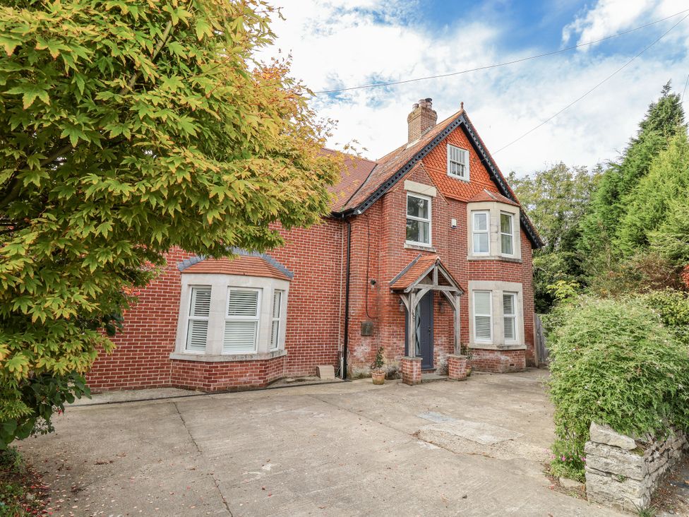 An exterior view of a house with a driveway at 49 Ulwell Road, Swanage