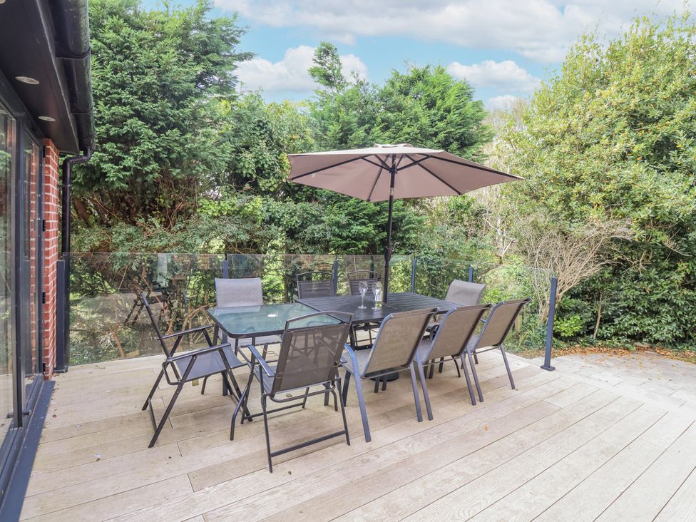 An outdoor patio with a table and chairs at 49 Ulwell Road in Swanage