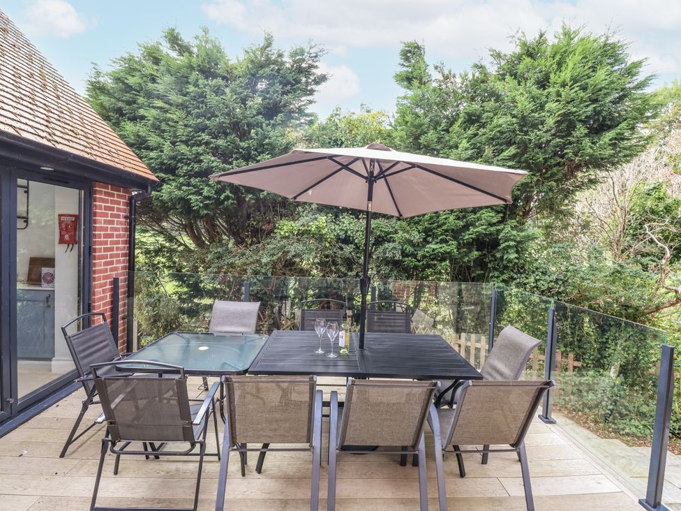 An outdoor seating area with a table and chairs at 49 Ulwell Road, Swanage