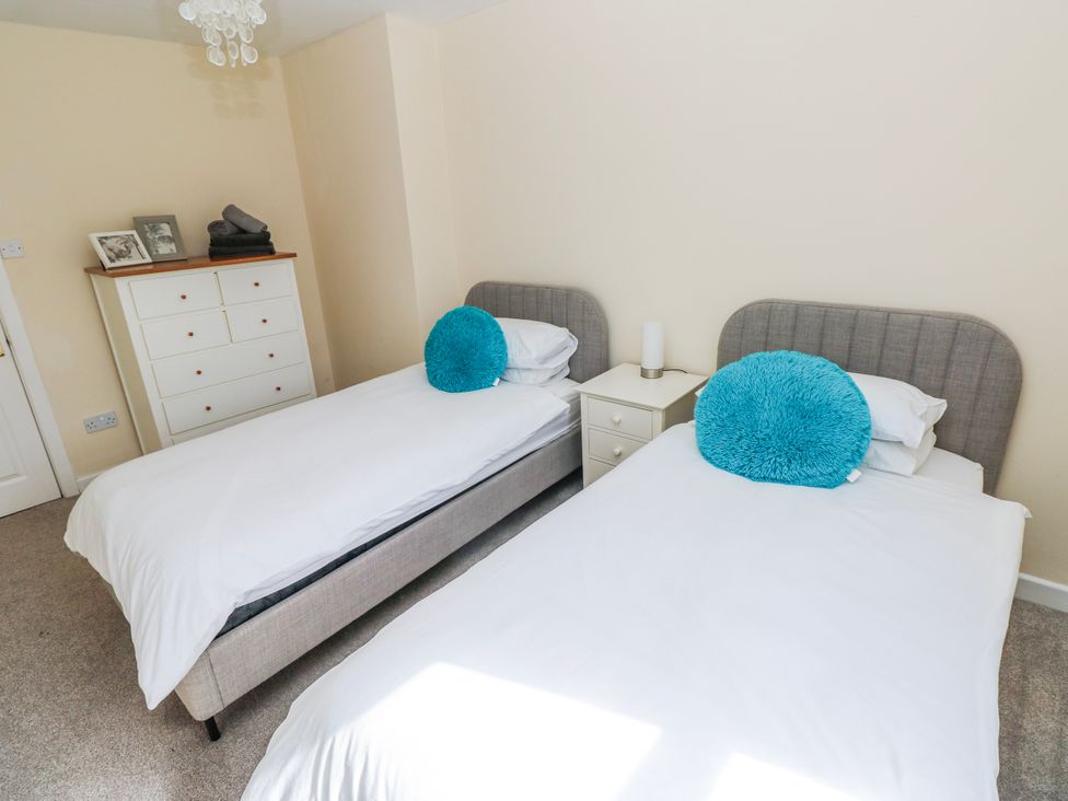 A bedroom with two beds and a dresser at Mountain Farm in Broad Haven