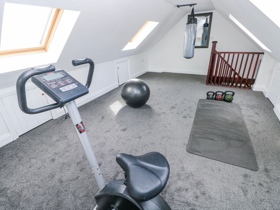 A gym with exercise equipment and a punching bag at Mountain Farm in Broad Haven