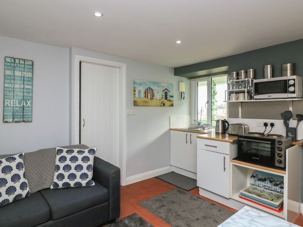 A kitchen with cabinets and appliances at Hidden Treasure in Brixham