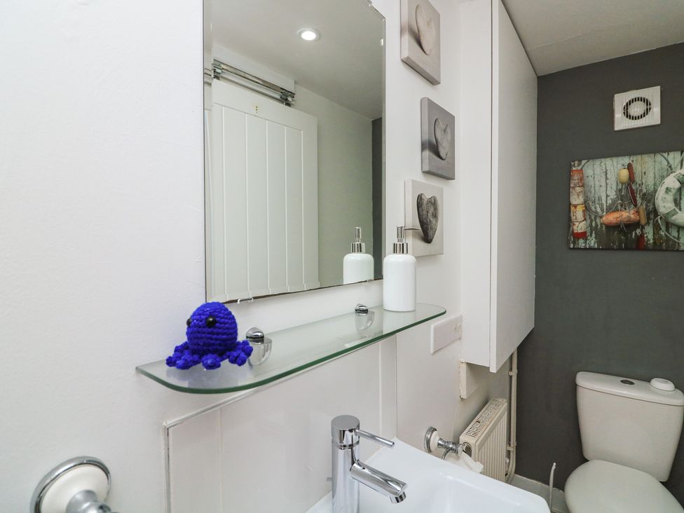 A bathroom with a sink and toilet at Hidden Treasure in Brixham