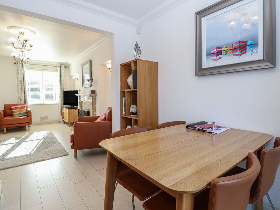 A dining area with a table and chairs at 5 Styleman Road in Hunstanton