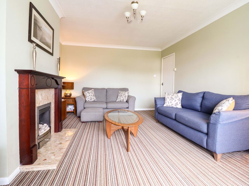 A living room with a sofa and coffee table at Castle Cove, Abergele