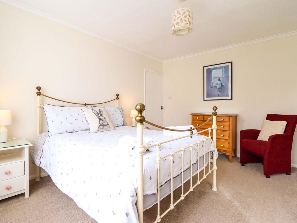 A bedroom with a bed and a nightstand at Castle Cove in Abergele
