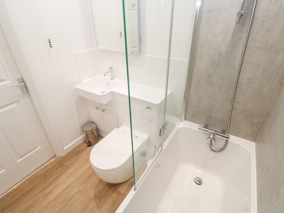 A bathroom with a sink and bathtub at Pilchard Cottage Sennen Cove