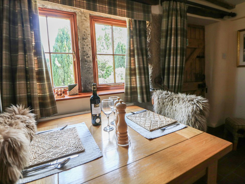 A dining room with a table set for dinner at Green Farm Cottage Hognaston near Carsington Water
