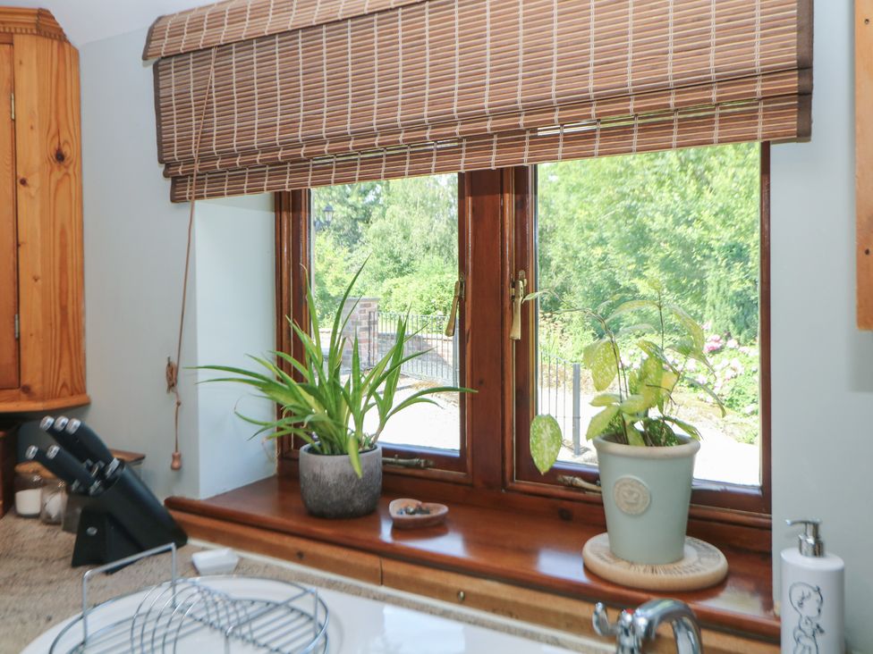 A kitchen with window and plants at Green Farm Cottage Hognaston near Carsington Water