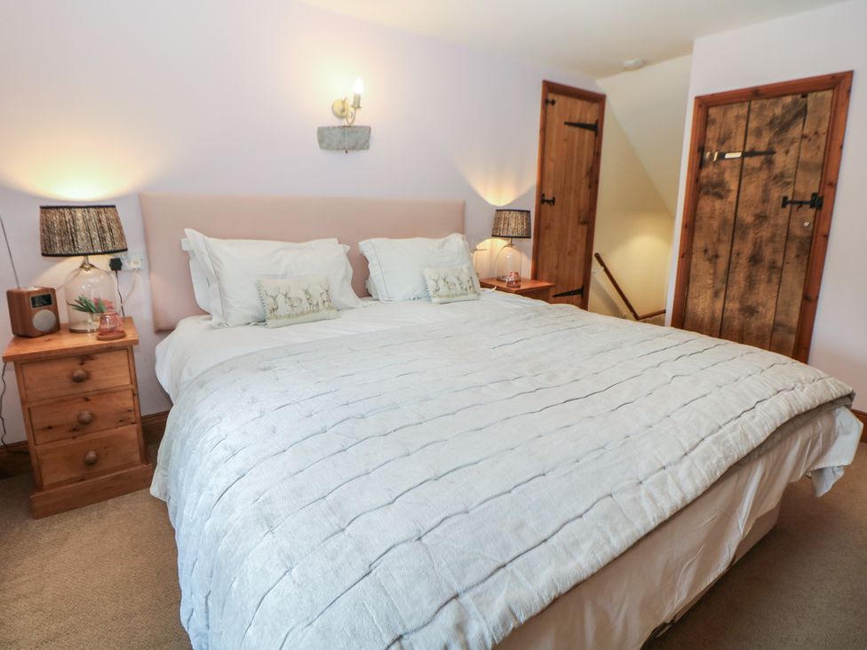 A bedroom with a double bed and nightstands at Green Farm Cottage Hognaston near Carsington Water