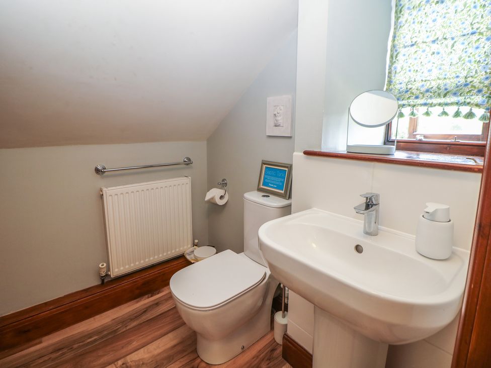 A bathroom with a toilet and sink at Green Farm Cottage in Hognaston near Carsington Water