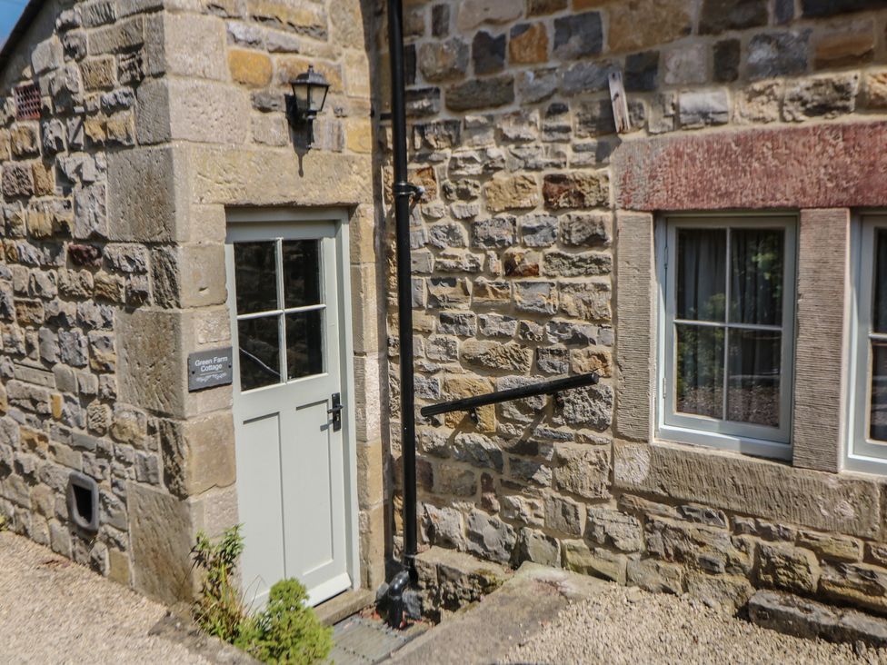 An exterior view of a door and window at Green Farm Cottage in Hognaston near Carsington Water