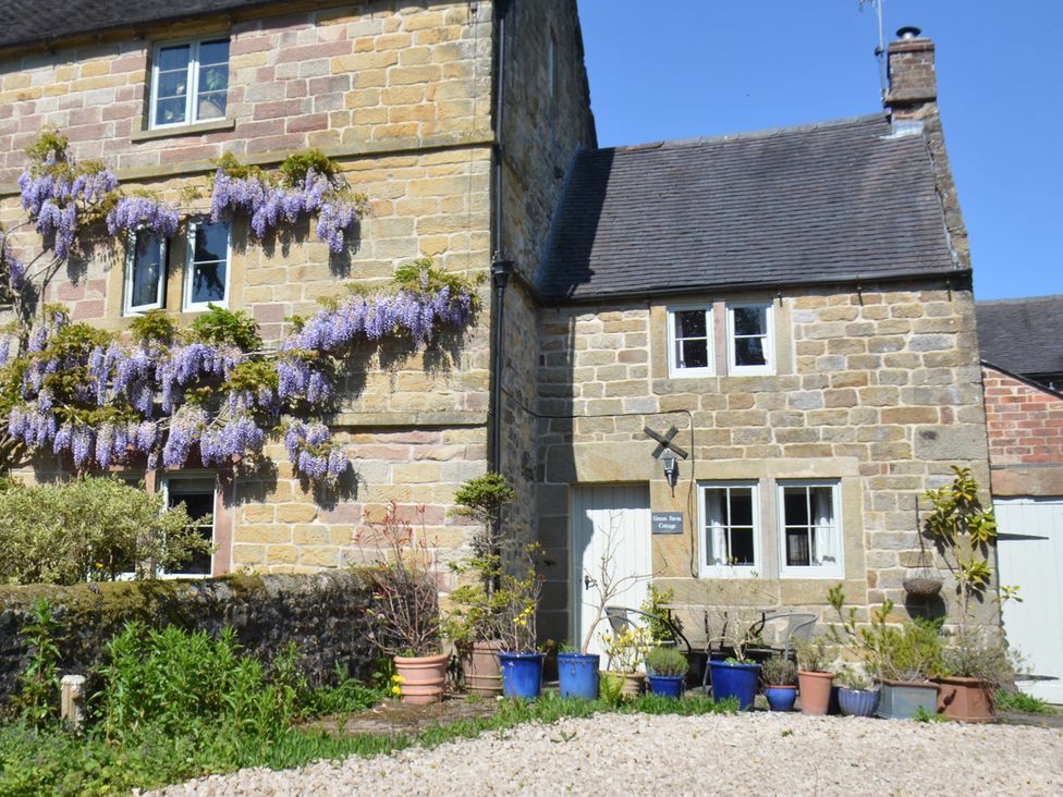 A house with wisteria flowers at Green Farm Cottage in Hognaston near Carsington Water