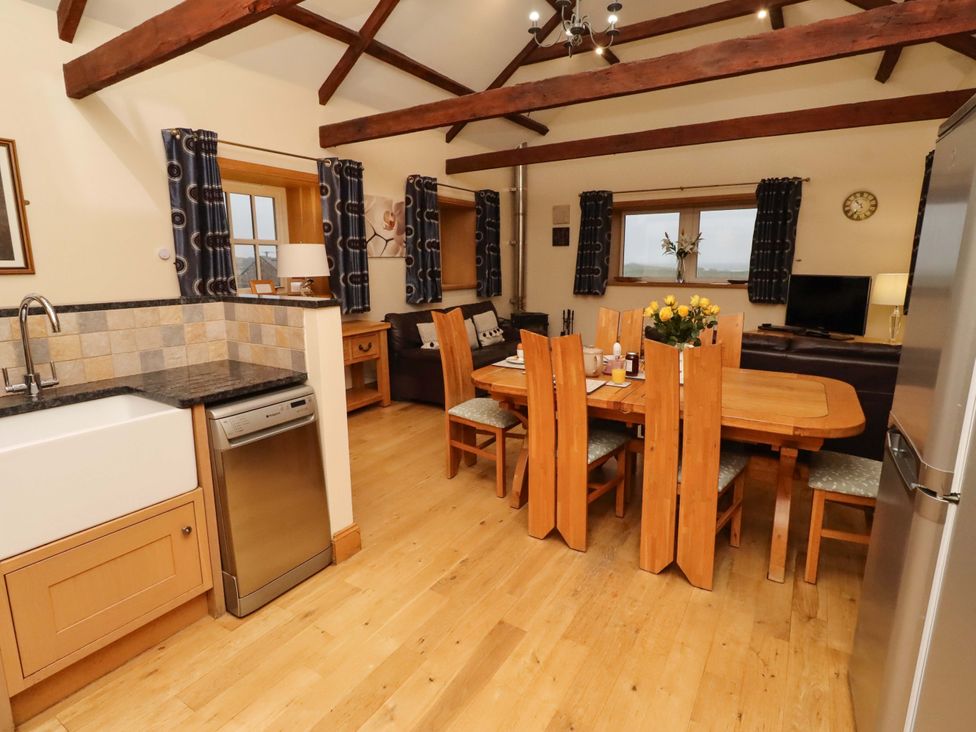A kitchen with a dining area and appliances at Stable D'or Embleton
