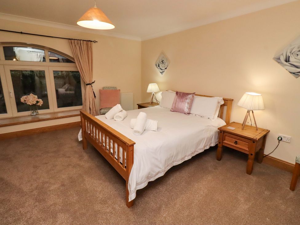 A bedroom with a bed and bedside tables at Stable D'or in Embleton