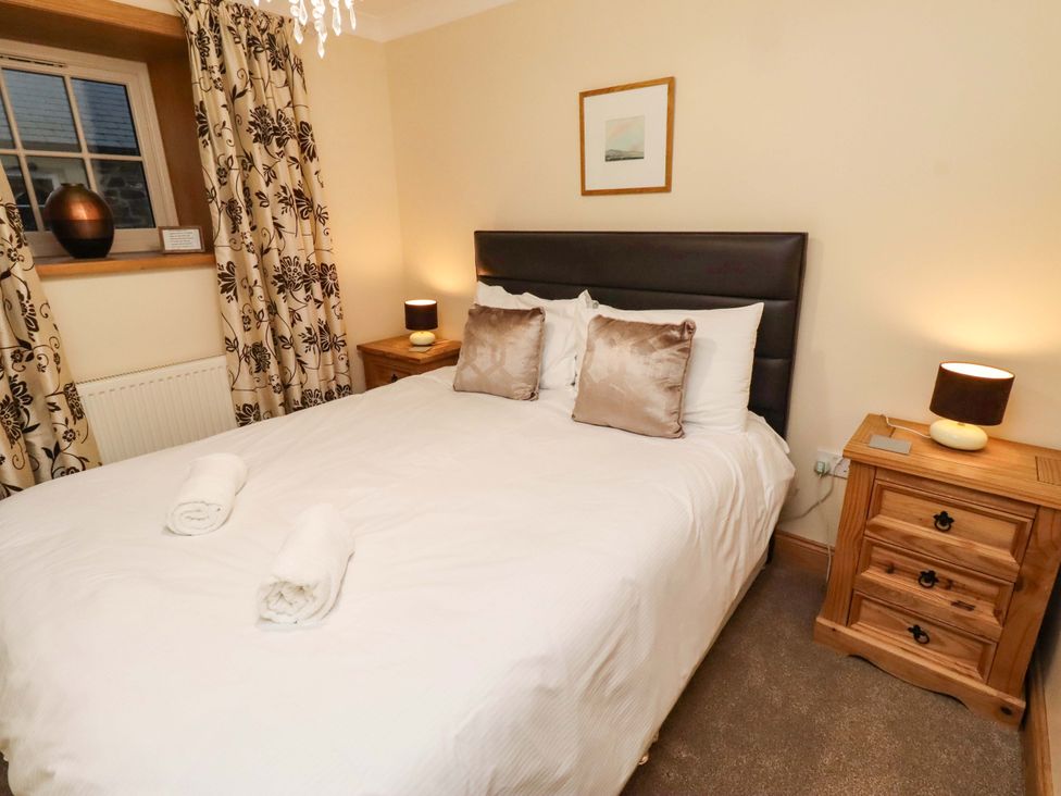 A bedroom with a bed and bedside table at Stable D'or in Embleton