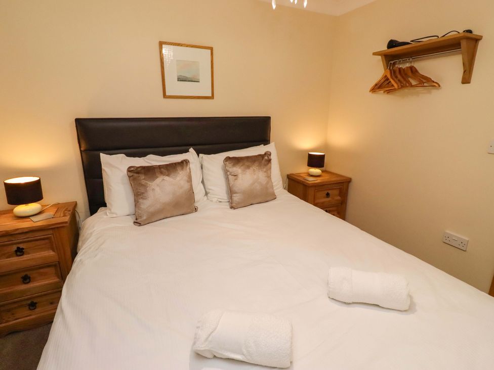 A bedroom with a bed and nightstands at Stable D'or in Embleton