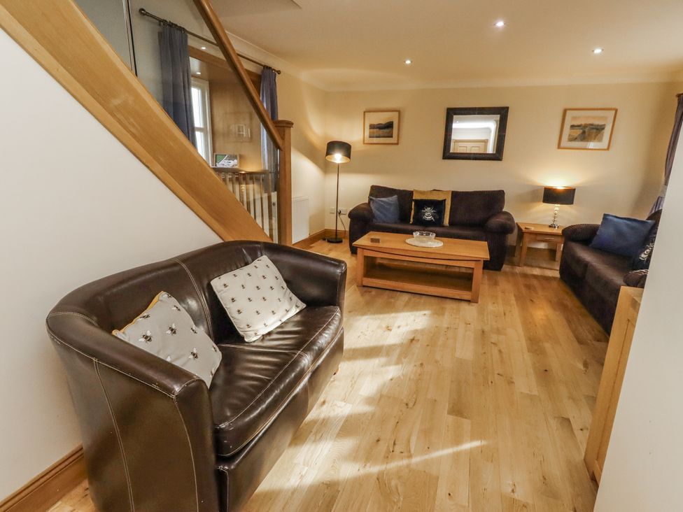A living room with sofas and a coffee table at Low Croft in Embleton