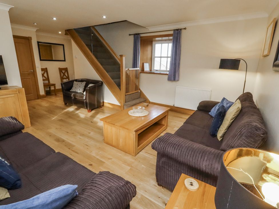 A living room with sofa and coffee table at Low Croft in Embleton