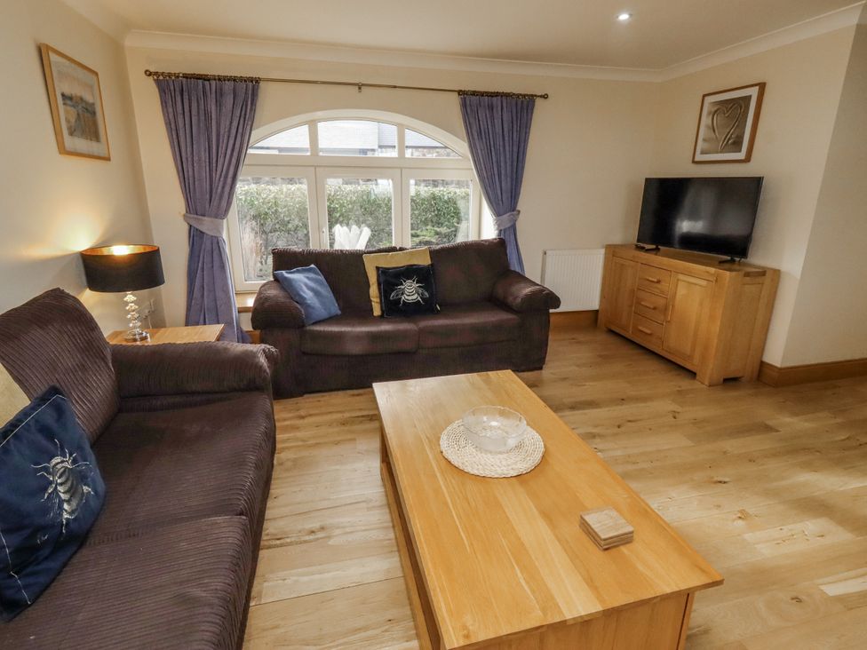 A living room with a sofa and television at Low Croft in Embleton