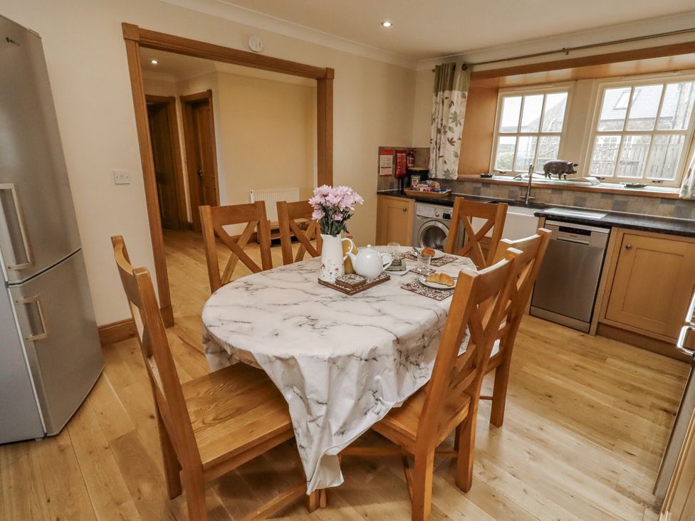 A kitchen with a table and chairs at Low Croft in Embleton