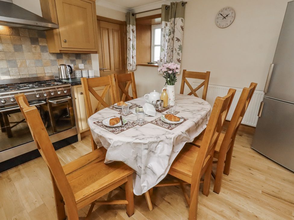 A dining room with a table set for breakfast at Low Croft in Embleton