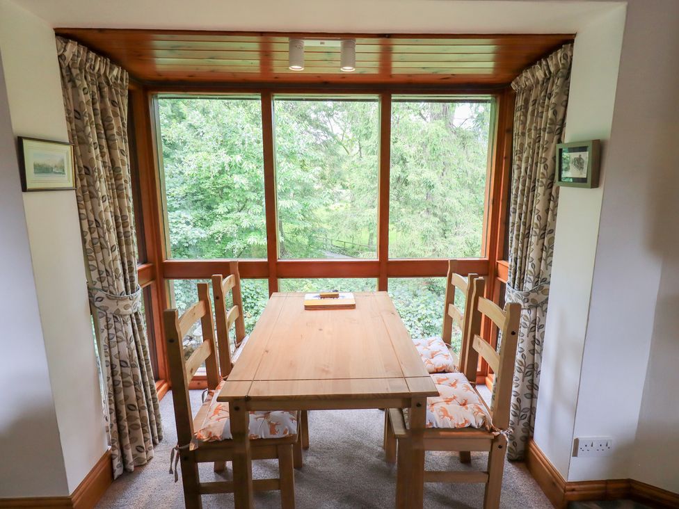 A dining room with a table and chairs at Drystones in Grasmere
