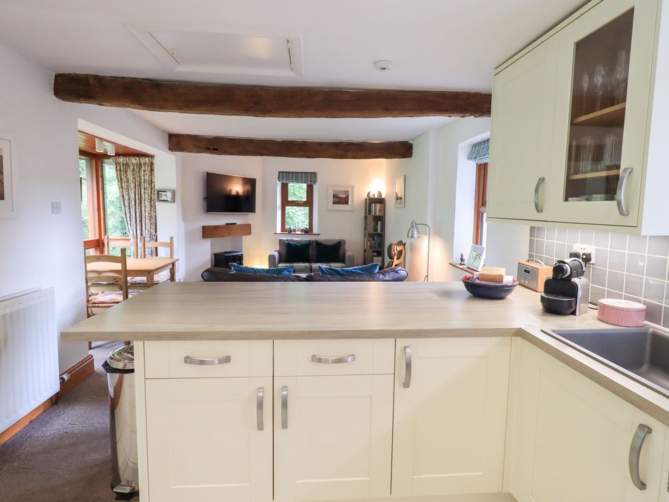 A kitchen with counter and seating area at Drystones Grasmere