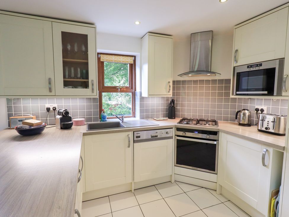 A kitchen with cabinets, sink, and appliances at Drystones in Grasmere