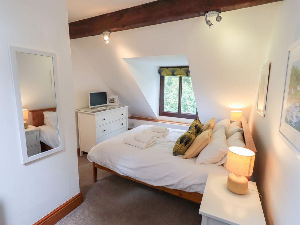 A bedroom with a bed and a television at Drystones in Grasmere