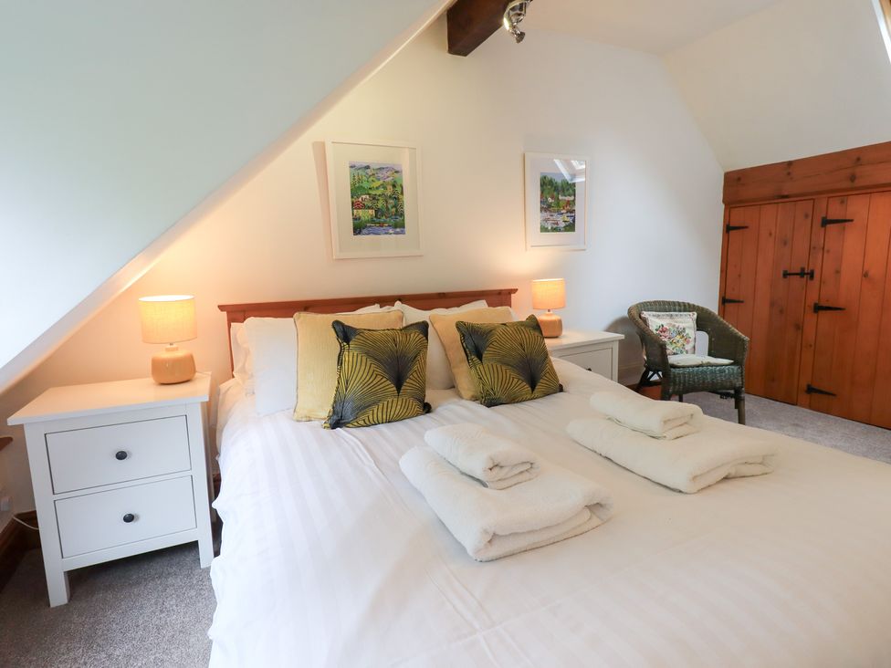 A bedroom with a bed and bedside tables at Drystones in Grasmere