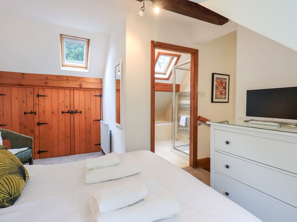 A bedroom with a bed and dresser at Drystones in Grasmere