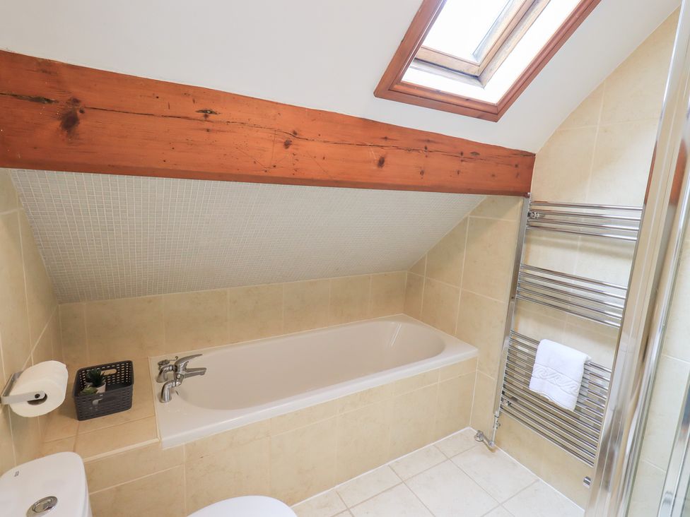 A bathroom featuring a bathtub and a towel radiator at Drystones in Grasmere