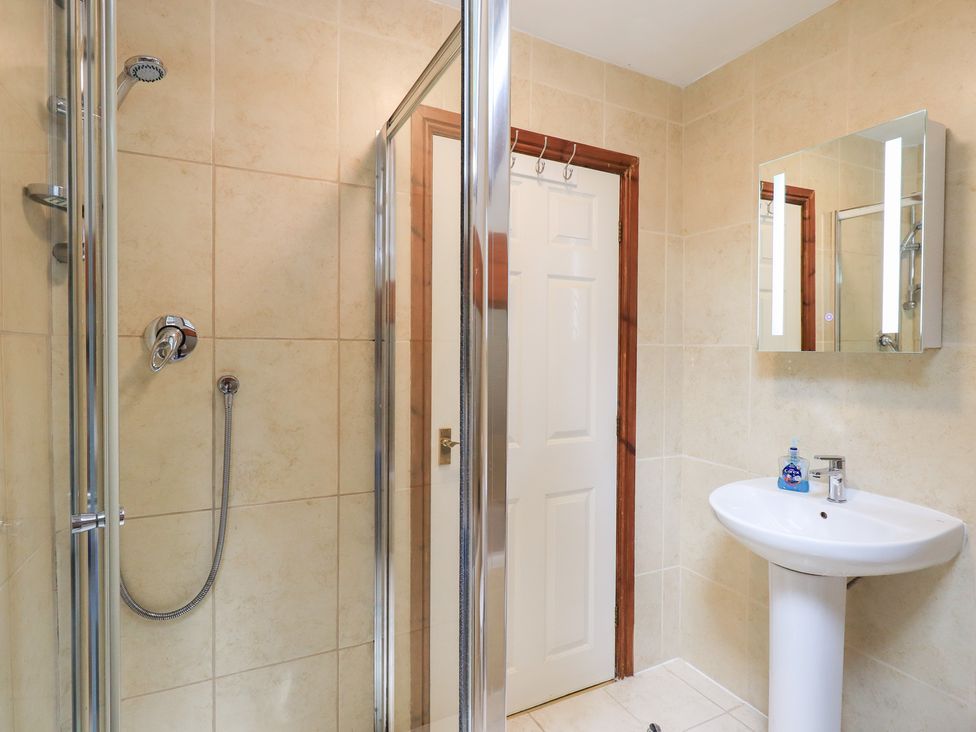A bathroom with a shower and sink at Drystones in Grasmere