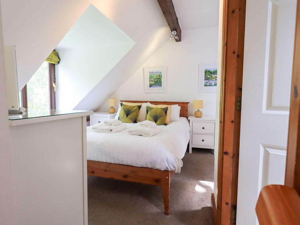 A bedroom with a double bed and bedside tables at Drystones in Grasmere