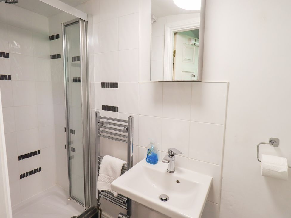 A bathroom with a shower and sink at Drystones in Grasmere