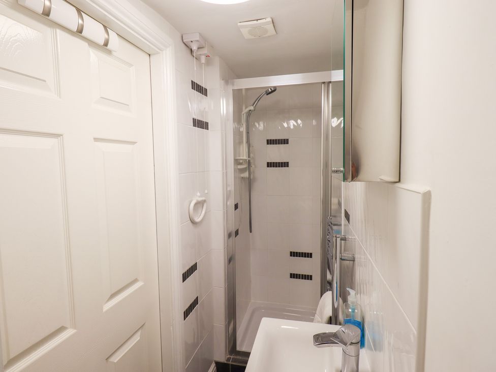 A bathroom with a shower and sink at Drystones in Grasmere