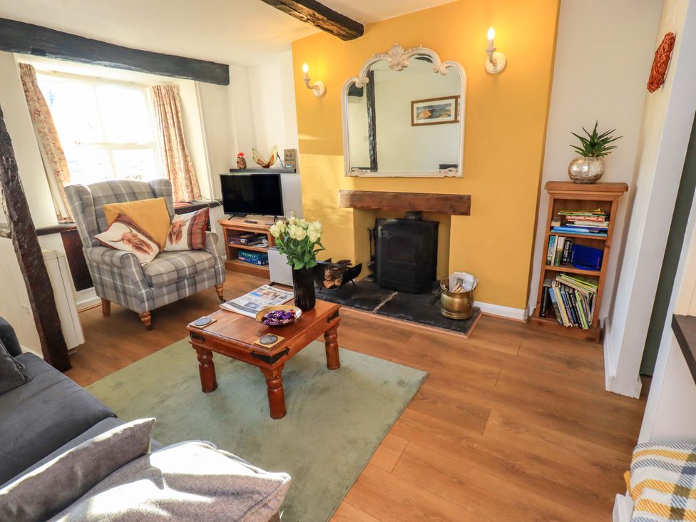 A living room with a coffee table and sofa at Buttonhole Cottage in Ambleside
