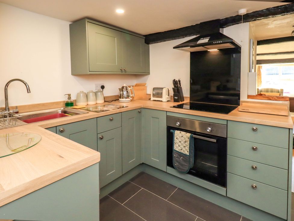 A kitchen with modern appliances at Buttonhole Cottage in Ambleside