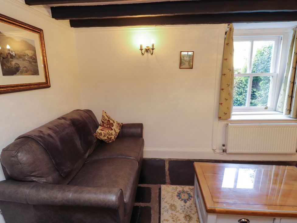 A snug with a sofa and coffee table at Sunbeam Cottage in Coniston
