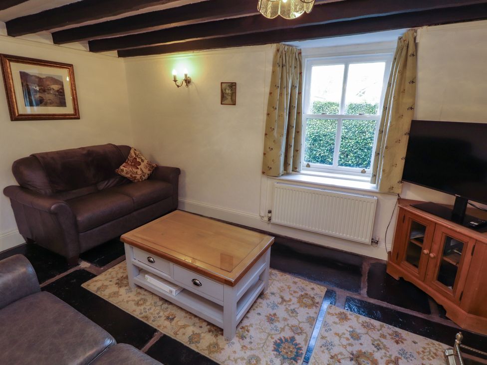 A living room with a sofa and coffee table at Sunbeam Cottage in Coniston